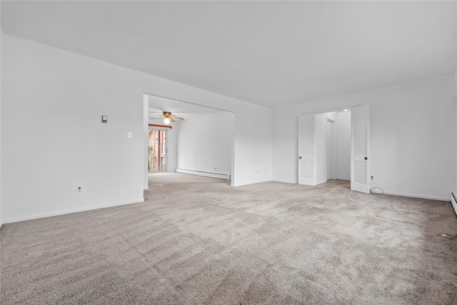 carpeted spare room with a baseboard heating unit and ceiling fan