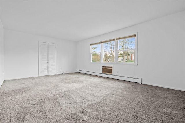 unfurnished room featuring carpet floors, a baseboard radiator, and baseboards