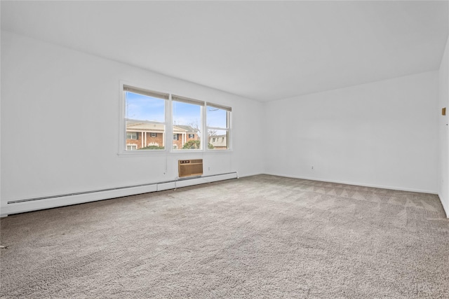 carpeted empty room with a baseboard radiator and baseboards