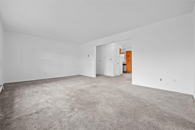 unfurnished room featuring light colored carpet