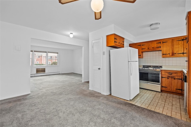 kitchen featuring a baseboard radiator, electric range, decorative backsplash, freestanding refrigerator, and light carpet