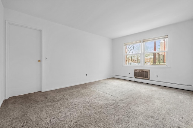 empty room with a baseboard heating unit and carpet flooring