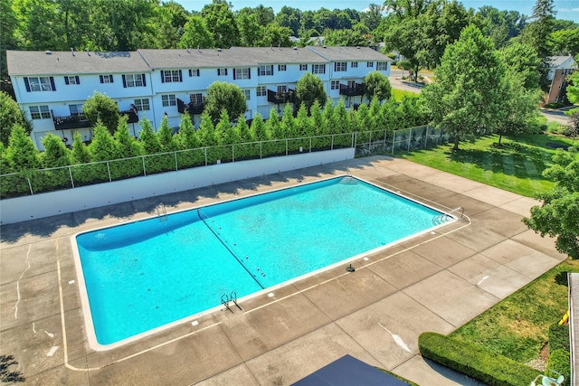 pool with a residential view, fence, and a patio