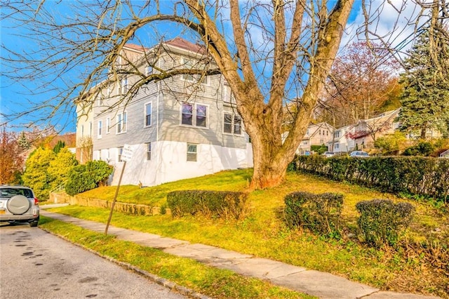 view of home's exterior with a yard and fence