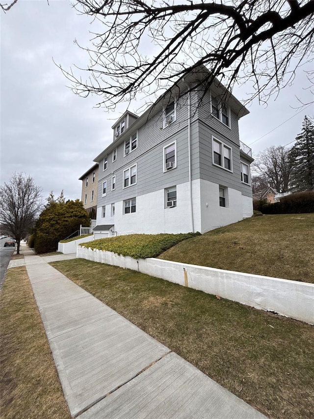 view of side of home with a lawn