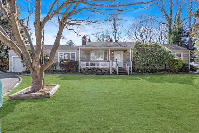 ranch-style house with aphalt driveway, a front yard, covered porch, a chimney, and a garage