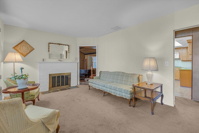 carpeted living area featuring a fireplace