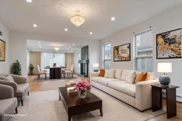 living area featuring a healthy amount of sunlight, light wood-style floors, and recessed lighting