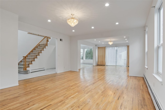 unfurnished living room featuring light wood finished floors, stairs, a baseboard heating unit, and recessed lighting