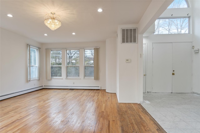 entryway with wood finished floors, visible vents, and recessed lighting