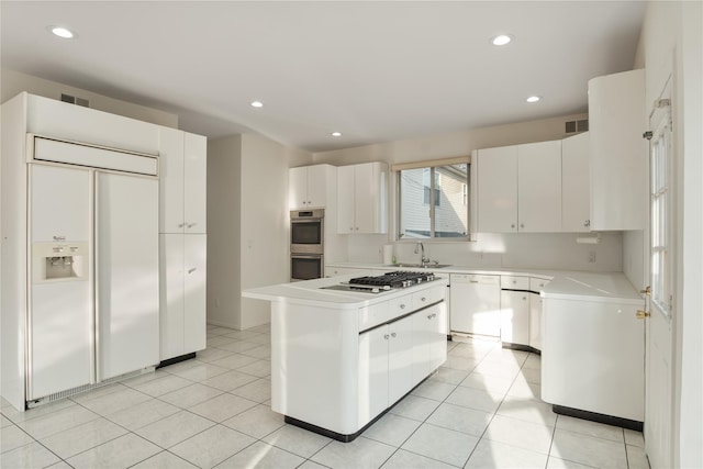 kitchen with a center island, light tile patterned flooring, a sink, white cabinetry, and white appliances