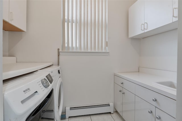 clothes washing area with cabinet space, independent washer and dryer, a sink, and baseboard heating