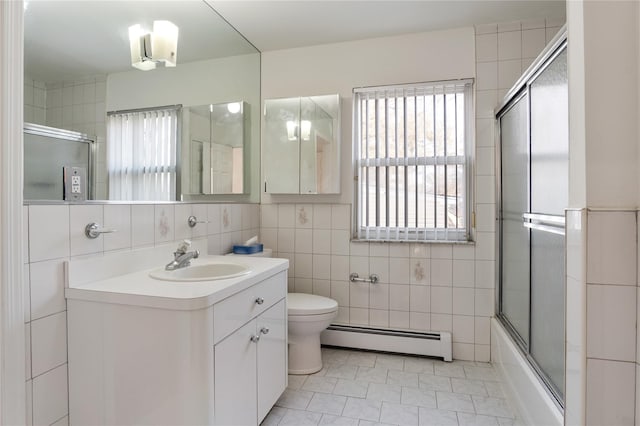 bathroom featuring toilet, a baseboard radiator, tile walls, and vanity