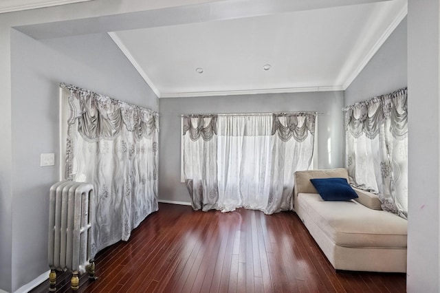 sitting room with crown molding, wood-type flooring, and radiator