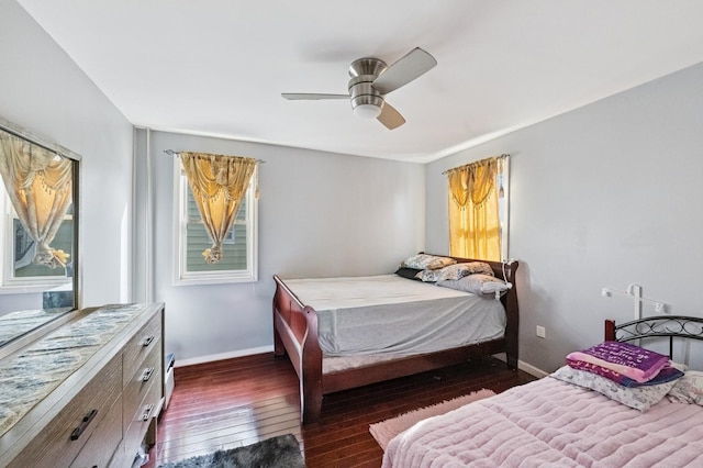 bedroom with a ceiling fan, baseboards, and hardwood / wood-style floors