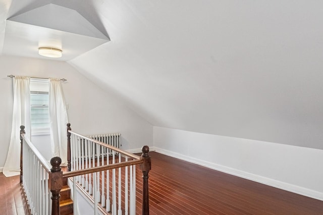 additional living space featuring lofted ceiling, radiator heating unit, wood finished floors, and baseboards