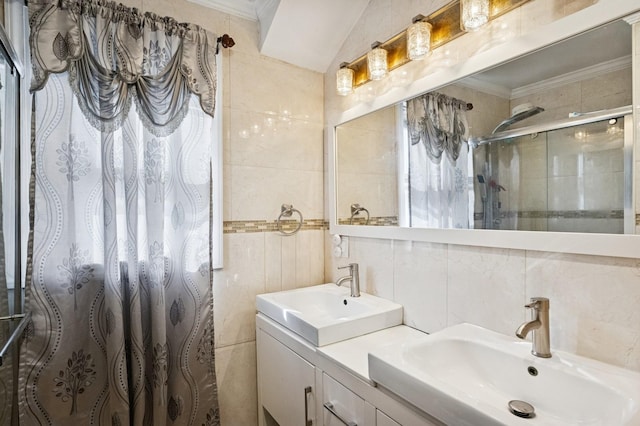 bathroom with ornamental molding, a stall shower, and a sink