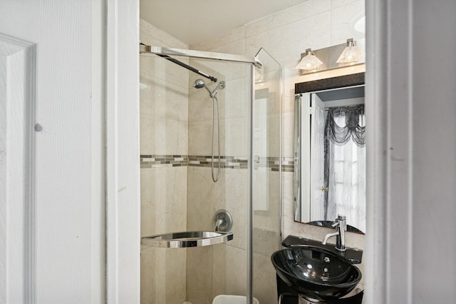 full bathroom with a stall shower and a sink