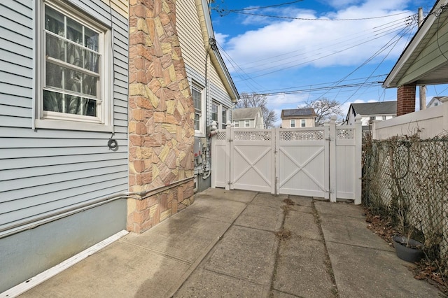 view of patio with a gate and fence