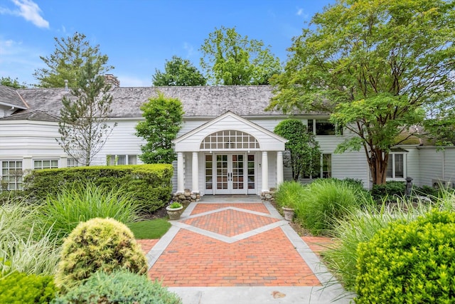 2 Aspen Pl, Great Neck, NY 11021 - view of front facade featuring french doors and a chimney