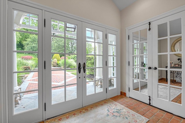 2 Aspen Pl, Great Neck, NY 11021 - doorway with french doors, brick flooring, and lofted ceiling