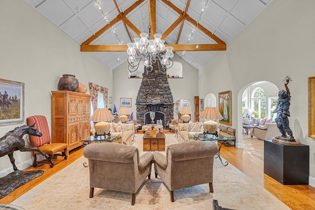 2 Aspen Pl, Great Neck, NY 11021 - living room featuring wood finished floors, high vaulted ceiling, a chandelier, baseboards, and a fireplace