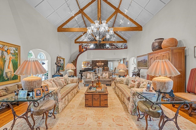 2 Aspen Pl, Great Neck, NY 11021 - living room featuring high vaulted ceiling, a chandelier, wood finished floors, and beam ceiling