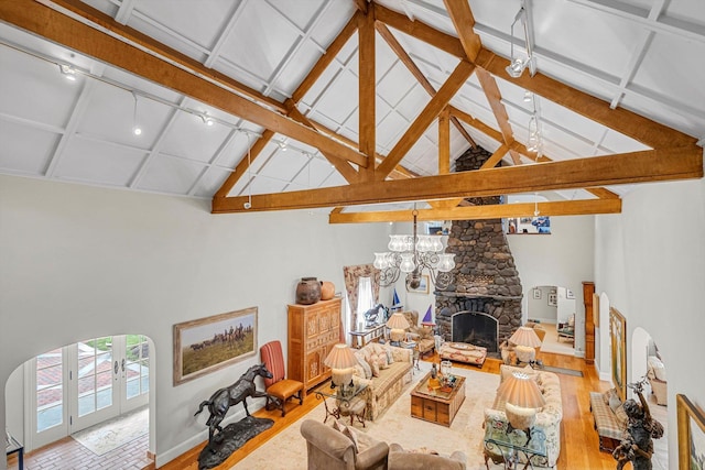 2 Aspen Pl, Great Neck, NY 11021 - living area featuring a fireplace, wood finished floors, baseboards, high vaulted ceiling, and a chandelier