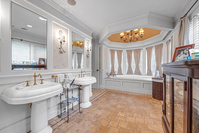 2 Aspen Pl, Great Neck, NY 11021 - bathroom featuring a decorative wall, a bath, a chandelier, crown molding, and a wainscoted wall