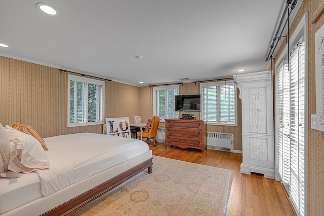 2 Aspen Pl, Great Neck, NY 11021 - bedroom with radiator heating unit, wallpapered walls, wood finished floors, crown molding, and recessed lighting