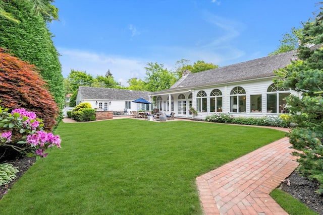 2 Aspen Pl, Great Neck, NY 11021 - view of green lawn featuring a patio area and french doors