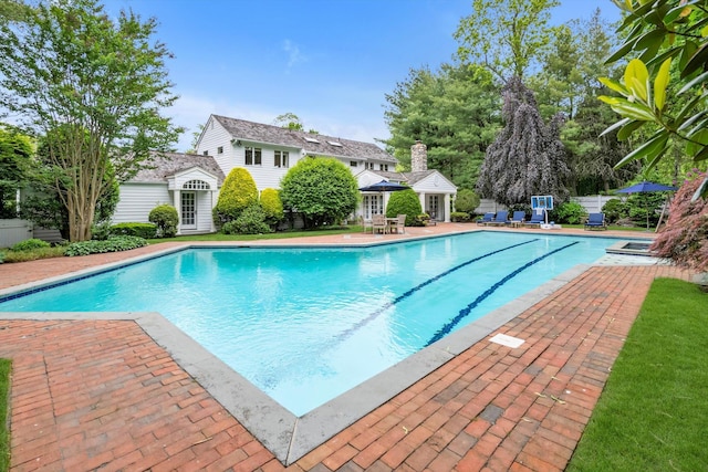 2 Aspen Pl, Great Neck, NY 11021 - outdoor pool featuring a storage structure, a patio area, an outbuilding, and french doors