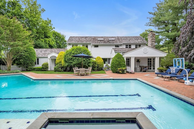 2 Aspen Pl, Great Neck, NY 11021 - outdoor pool with a patio area, an outdoor structure, an exterior structure, and french doors