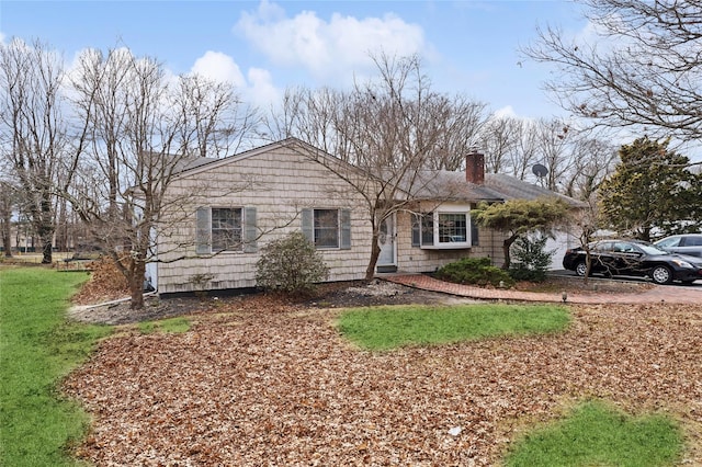 single story home with a garage and a chimney