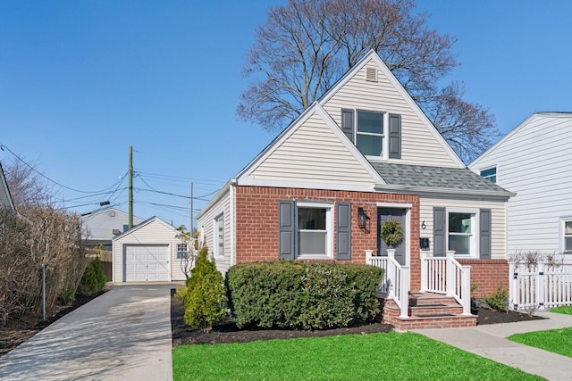 bungalow featuring brick siding, fence, concrete driveway, a garage, and an outdoor structure