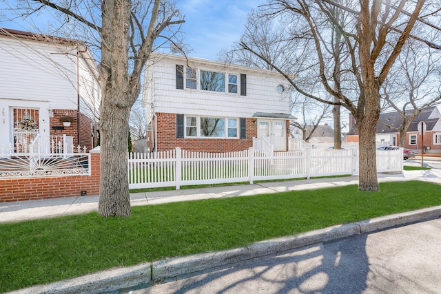 view of front of property with brick siding and a fenced front yard