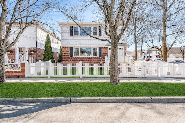 view of front of property with brick siding and a fenced front yard