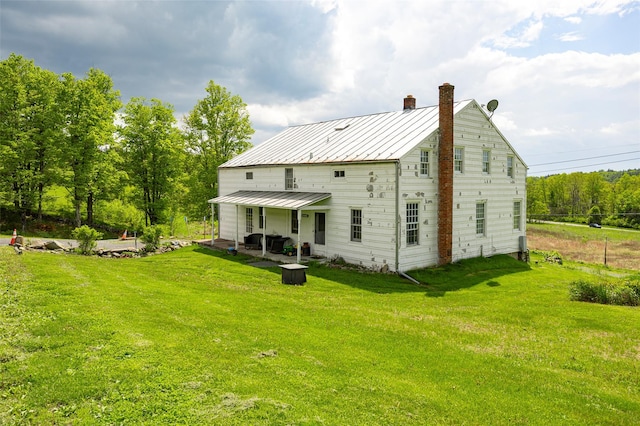 148 N Creek Rd, Staatsburg, NY 12580 - rear view of house featuring a chimney, a lawn, and a standing seam roof