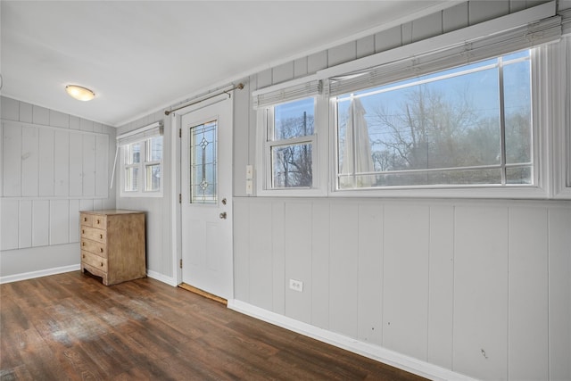 interior space with baseboards and dark wood-style flooring