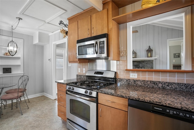 kitchen with decorative backsplash, appliances with stainless steel finishes, and brown cabinetry