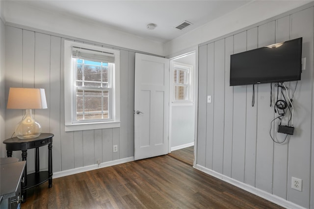 interior space with visible vents, baseboards, and dark wood-style flooring