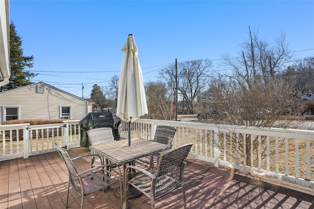 wooden deck featuring outdoor dining area