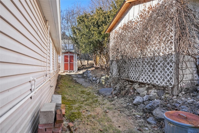 view of yard featuring a storage shed and an outdoor structure