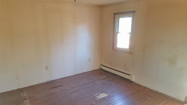 empty room with a baseboard radiator and wood finished floors