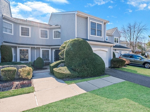 view of front of property with a garage and a front lawn