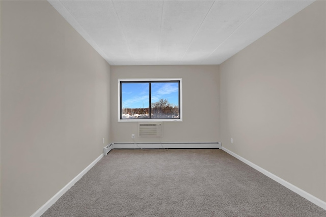 spare room with carpet floors, a baseboard radiator, a wall mounted air conditioner, and baseboards