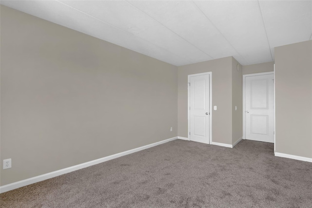 carpeted spare room with baseboards