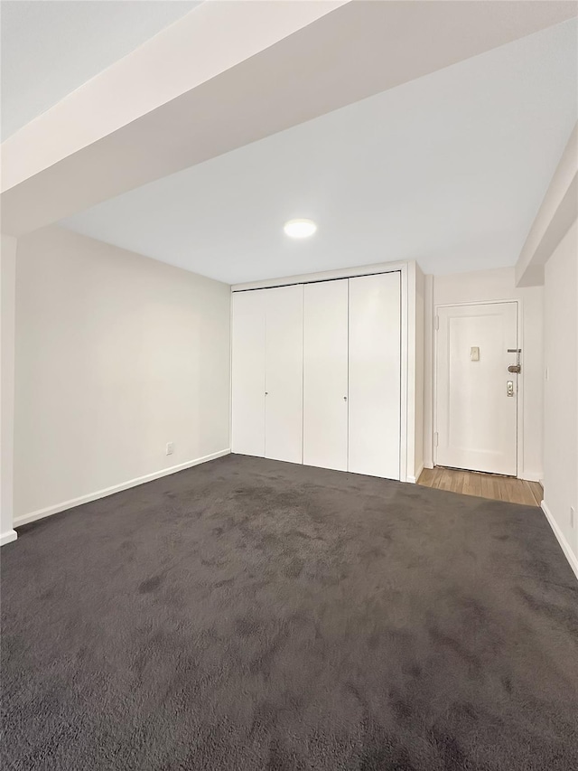 interior space with carpet, a closet, and baseboards