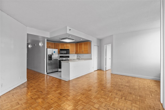 kitchen with range with gas cooktop, black microwave, a textured ceiling, and stainless steel fridge with ice dispenser