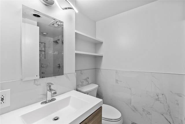 full bathroom with vanity, walk in shower, toilet, and tile walls